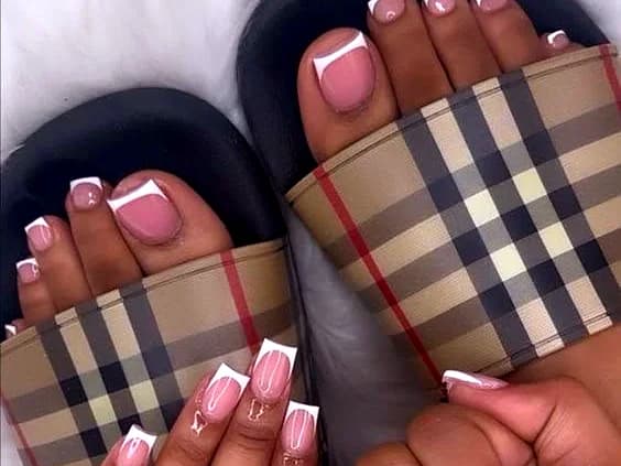 Matching pink French-tip manicure and pedicure with crisp white tips